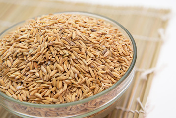 paddy rice in bowl on wood placemats