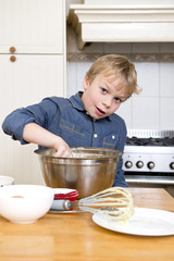 Young boy baking pies in a kitchen © corepics