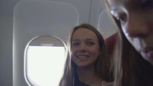 Young women traveling by plane together
