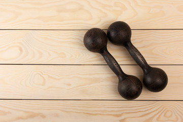 old dumbbells on wood background