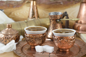 Copper plates and cups filled with coffee