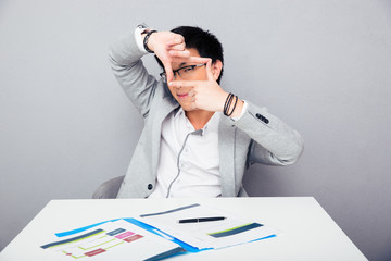 Businessman making frame with fingers