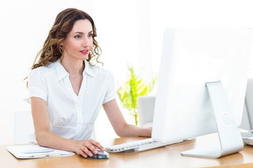 Smiling businesswoman working with computer