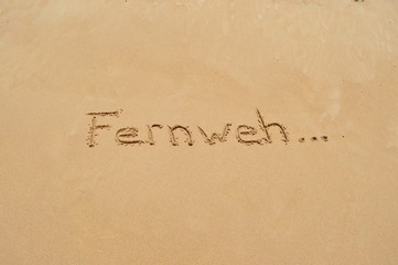 German word 'Fernweh' in the sand