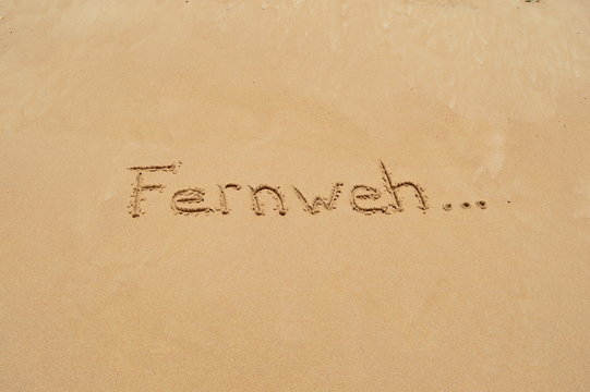 German word 'Fernweh' in the sand