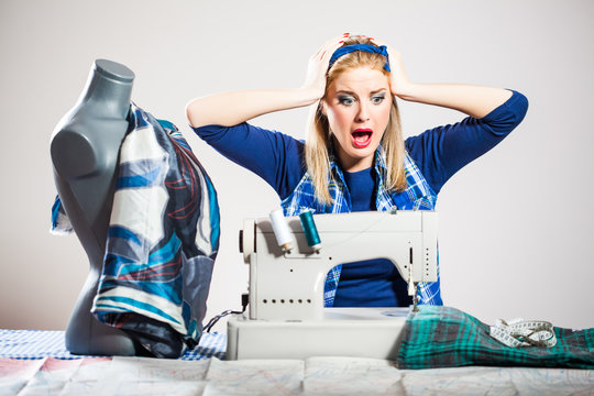 Woman sews and getting frustrated because she made a mistake