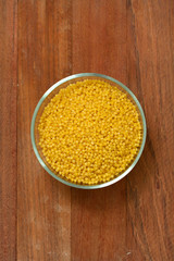 cous cous in bowl on brown background