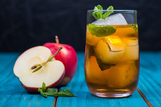 Glass of refreshing apple and mint juice with ice, drink backgro