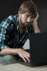 Lazy man using laptop