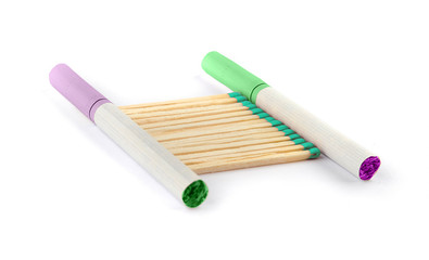 Two colored cigarettes and lined matches