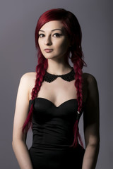 Fototapeta premium Beautiful woman with read hair, black dress and collar