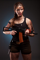 Fototapeta premium Beautiful woman with gun ak 47