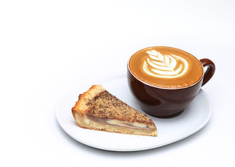 Cup of cappuccino and a piece of cake. Latte art