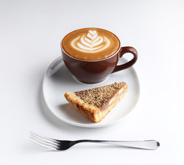 Cup of cappuccino and a piece of cake. Latte art. Isolated on wh