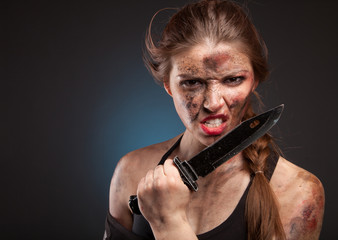 Sexy and hot military woman posing with knife. Ready to fight.