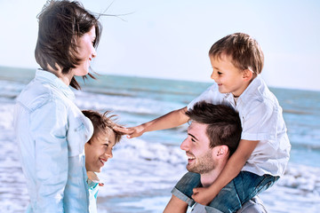 boy caresses his brother with love with his family to the sea