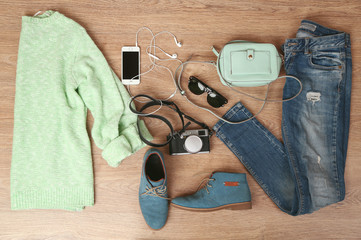 Still life of casual woman. Woman clothes and accessories on wooden background