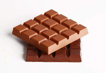 Milk and black chocolate bars isolated on white
