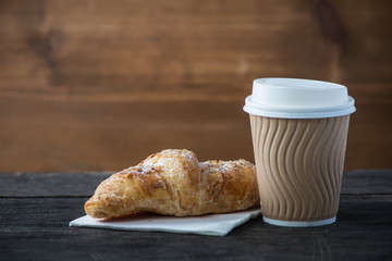 Take away coffee and fresh croissant