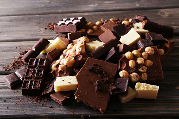 Set of chocolate with hazelnut on wooden table, closeup