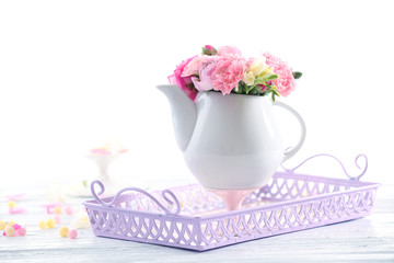 Beautiful spring flowers in teapot isolated on white