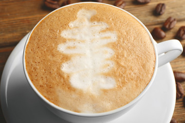 Cup of latte art coffee with grains, closeup