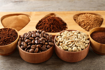 Various of coffee in small dishes on wooden table, closeup