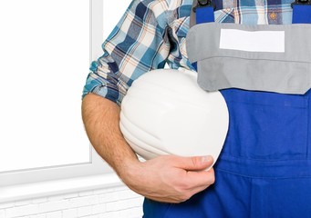Builder. Worker holding his helmet