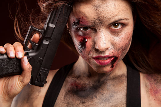 Woman warrior posing with knife. Ready to fight. With dirty face
