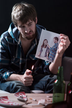 Man burning ex-girlfriend photo
