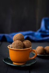 Candy with dates, chocolate and coconut on a dark background