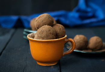 Candy with dates, chocolate and coconut on a dark background