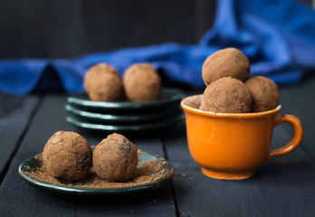 Candy with dates, chocolate and coconut on a dark background