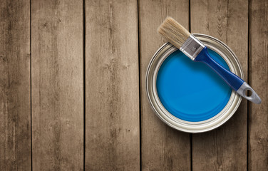 Paint can on the old wooden background with copy space