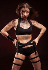 Woman warrior posing with knife. Ready to fight. With dirty face