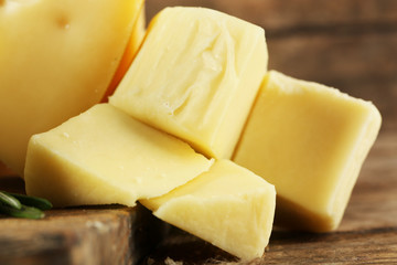 Different sort of cheese on wooden table, closeup