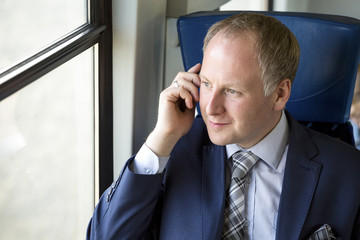 Businessman calling from a train