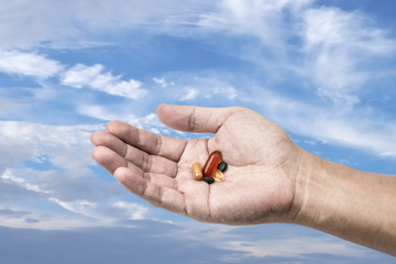 Drug in hand with sky background, Freedom to use drug concept