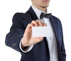 Elegant man in suit holding business card, isolated on white