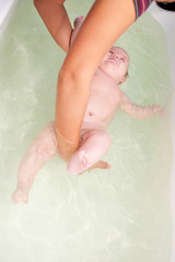 Fototapeta premium 3 month baby swimming in the bath