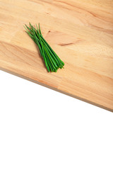 Green chives on wooden chopping board