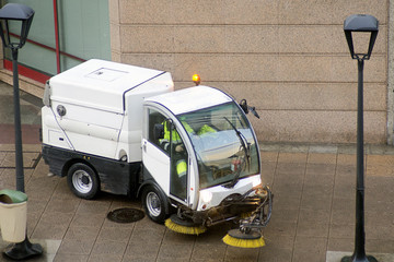 worker with street sweeper  electrical  vehicles cleaning the