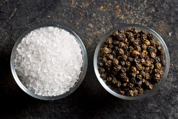 salt crystals and black peppercorns