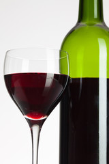 Wine glass and bottle with red wine
