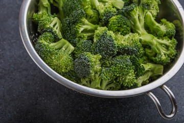 Pieces of broccoli in a sieve