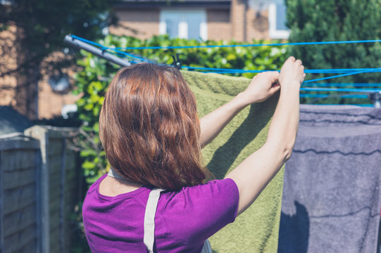Woman hanging her laundry in garden
