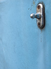 Old latch on a blue car.