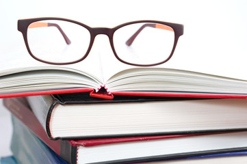 Glasses on book stacks