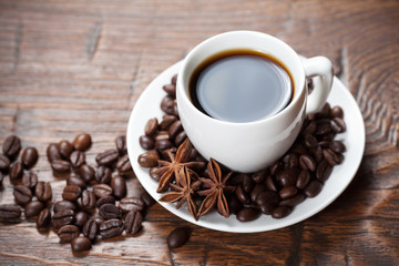 Cup of coffee with beans and spicery