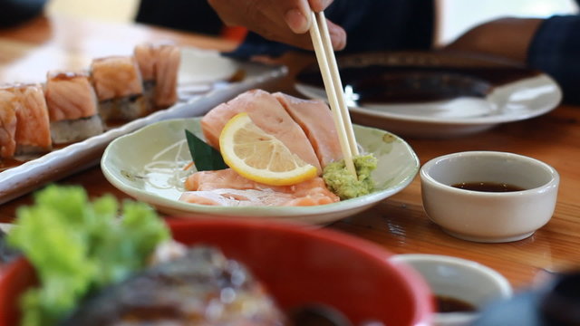 Salmon sashimi dipped in sauce